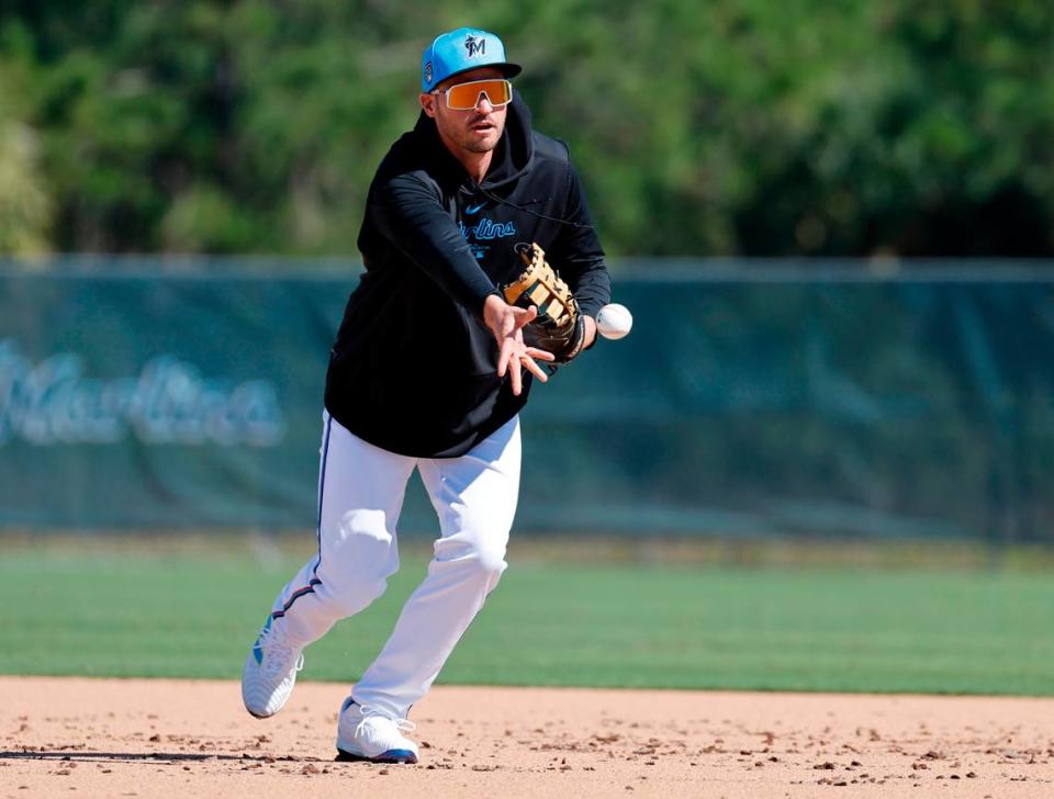 Miami Marlins first baseman Trey Mancini tosses the ball to first base during spring training at Roger Dean Chevrolet Stadium in Jupiter, Florida on Tuesday, February 20, 2024.