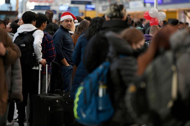 PHOTO: Passengers wait in line at O'Hare International Airport, Dec. 24, 2022, in Chicago. (Paul Beaty/AP)