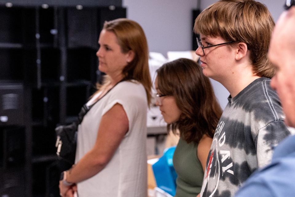 Ash Blakely, 13, right, attends an enrollment information meeting at one•n•ten discussing the opening of the Queer Blended Learning Center in partnership with Spark Community Schools in Phoenix on July 18, 2023.