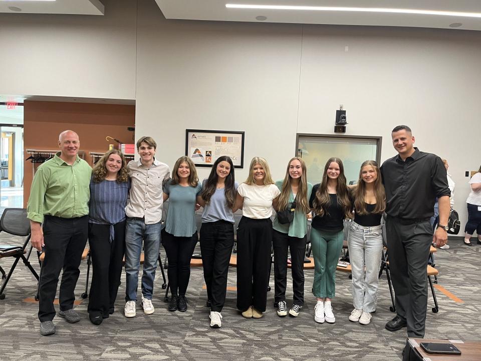 Terry Dvorak, CEO of Red Lion Renewables (left), and Collin Reichert, science teacher at Ames High School (right), stand with the "Solar Rangers." In alphabetical order: Anna Conn, Levi Crabb, Addy Danielson, Ashley Flattery, Eleanor Reynolds, Maegan Schoppe, Anleah Walker and Julian Weddle.
