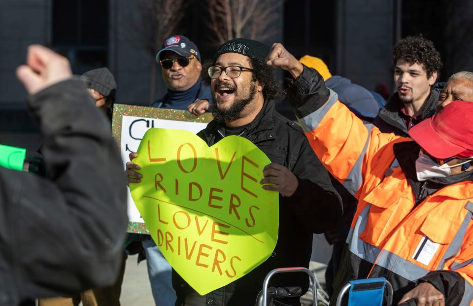 Renard Monczunski, a transit justice organizer for Detroit People's Platform, helps lead a chant during a rally for better bus services in front of the Spirit of Detroit statue outside the Coleman A. Young Municipal Center in Detroit on Feb. 14, 2023.