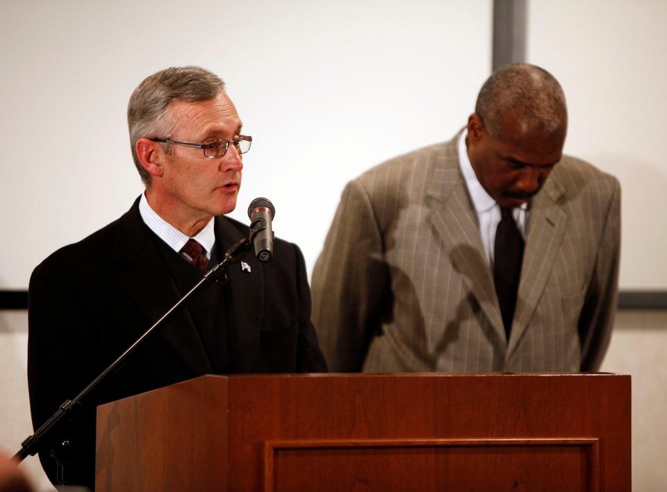 Ohio State football coach Jim Tressel answers questions while athletic director Gene Smith listens during a news conference in 2011.
