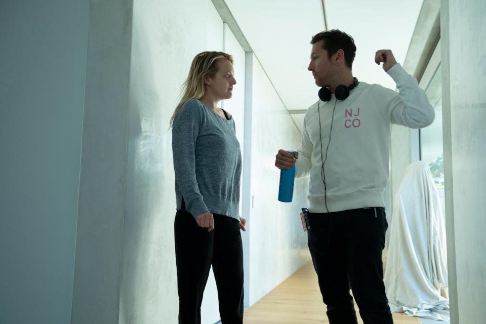 Elisabeth Moss and writer/director Leigh Whannell go over a scene on the set of "The Invisible Man."