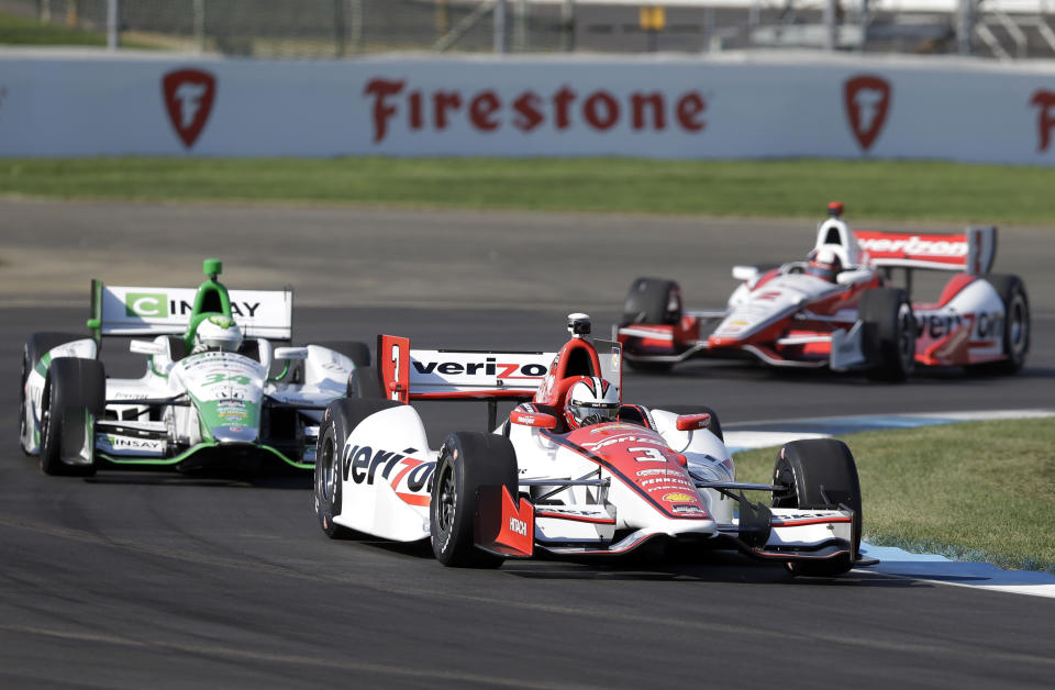 Helio Castroneves, of Brazil, (3) leads Carlos Munoz, of Bogota, left, and Juan Pablo Montoya, of Colombia, through turn 2 during practice for the inaugural Grand Prix of Indianapolis IndyCar auto race at the Indianapolis Motor Speedway in Indianapolis, Thursday, May 8, 2014. (AP Photo/Michael Conroy)