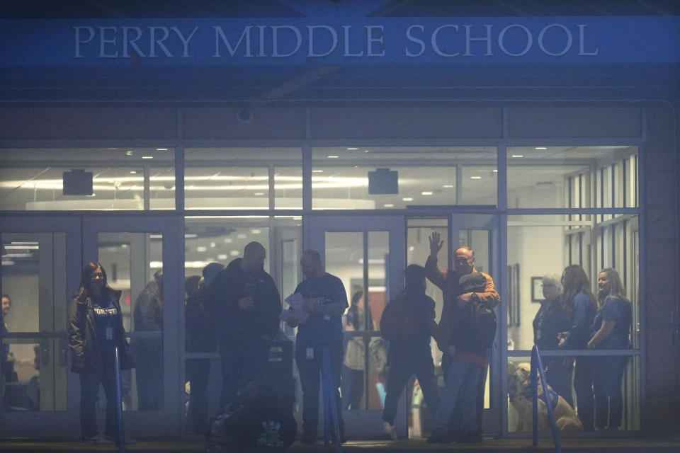 Students are greeted by staff as they arrive at Perry Middle School, Thursday, Jan. 25, 2024, in Perry, Iowa. Middle school students returned to classes Thursday for the first time since a high school student opened fire in a shared cafeteria, killing two people and injuring six others. (AP Photo/Charlie Neibergall)