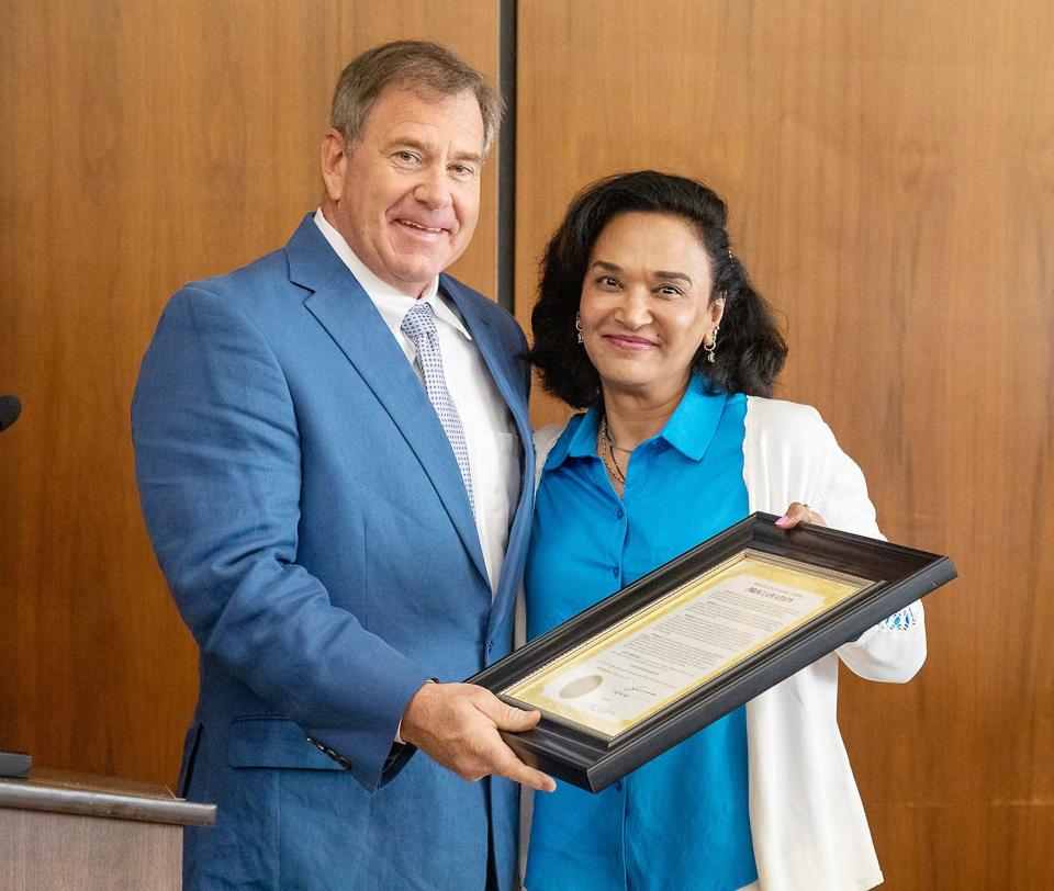 Mayor Craig Ford presents a commendation to Mamta Mishra, a local advocate for autism awareness, during the Gadsden City Council's April 11 meeting.