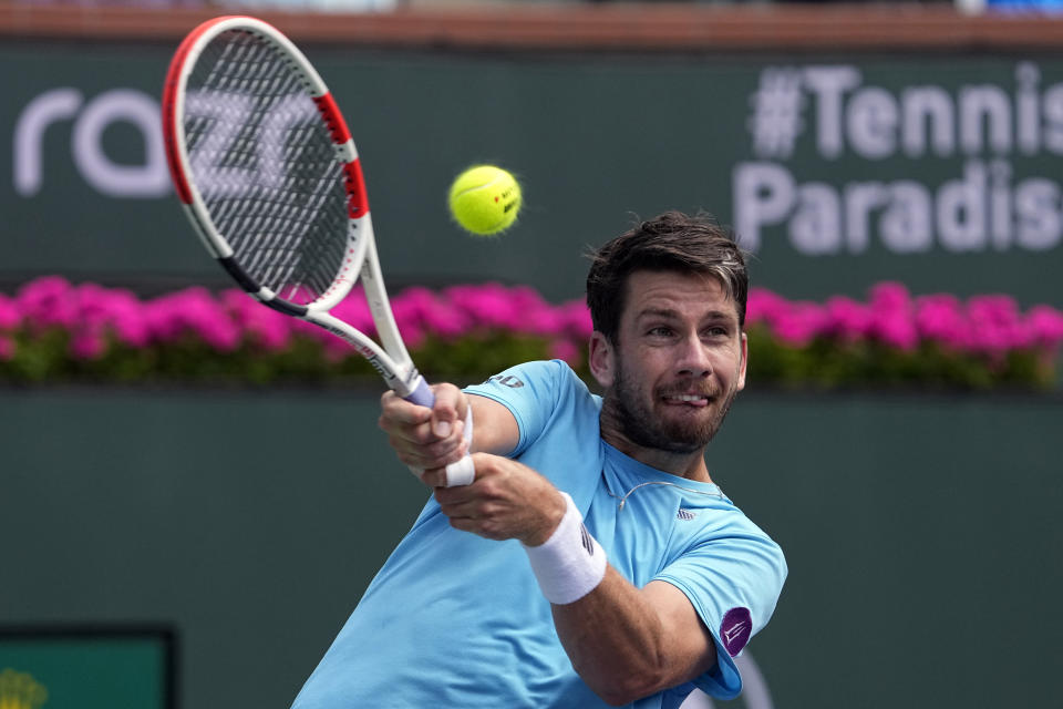 Cameron Norrie, of Britain, returns a shot to Frances Tiafoe, of the United States, at the BNP Paribas Open tennis tournament, Wednesday, March 15, 2023, in Indian Wells, Calif. (AP Photo/Mark J. Terrill)