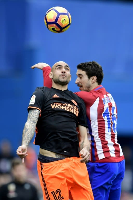 Valencia's forward Simone Zaza (L) vies with Atletico Madrid's Croatian defender Sime Vrsaljko during the Spanish league football match Club Atletico de Madrid vs Valencia CF at the Vicente Calderon stadium in Madrid on March 5, 2017