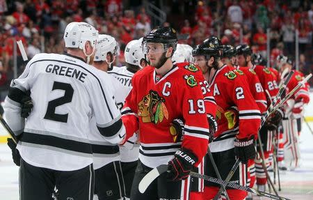 Jun 1, 2014; Chicago, IL, USA; Chicago Blackhawks center Jonathan Toews (19) shakes hands with Los Angeles Kings defenseman Matt Greene (2) after game seven of the Western Conference Final of the 2014 Stanley Cup Playoffs at United Center. Mandatory Credit: Jerry Lai-USA TODAY Sports