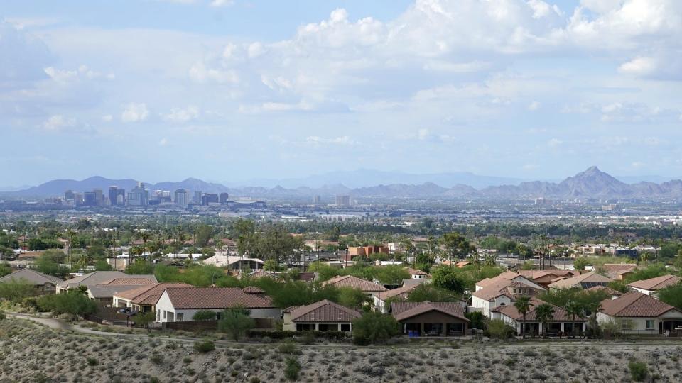 Downtown Phoenix with suburban homes in foreground.