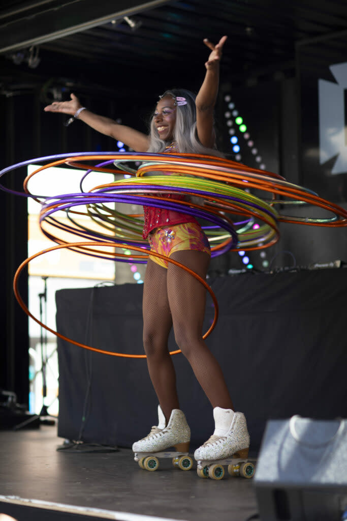A person hula-hooping in roller skates