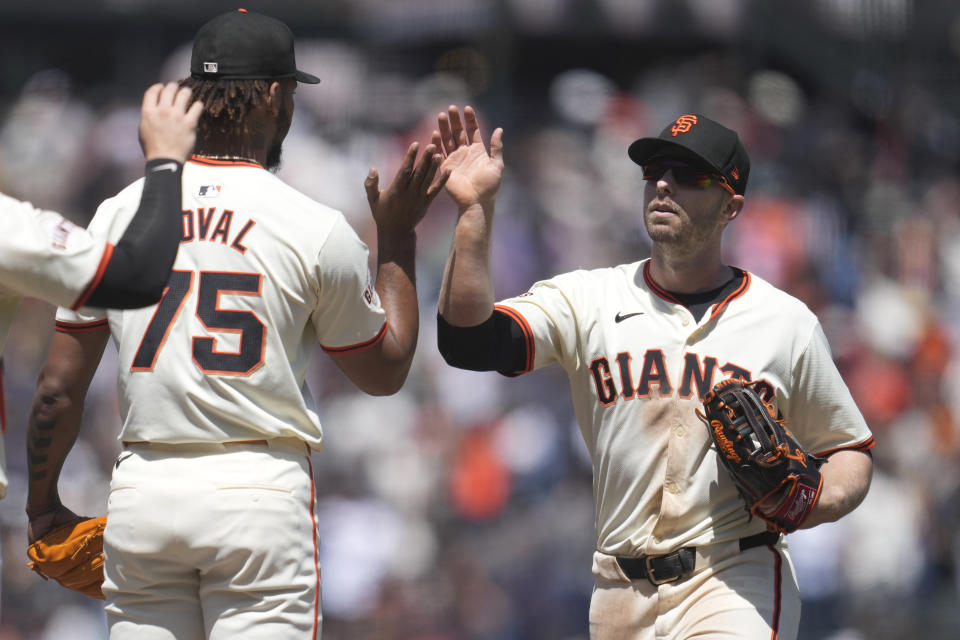 San Francisco Giants pitcher Camilo Doval (75) celebrates with left fielder Austin Slater (13) after the Giants defeated the Houston Astros in a baseball game in San Francisco, Wednesday, June 12, 2024. (AP Photo/Jeff Chiu)