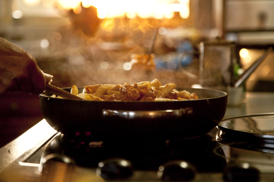 Cooking a pasta dish on a stove top in a domestic kitchen