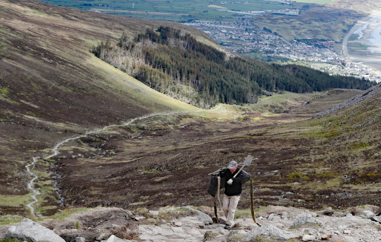 National Trust mountain ranger James Fisher constructing the final stages of the stone path on Slieve Donard in Newcastle, Co Down (Niall Carson/PA)
