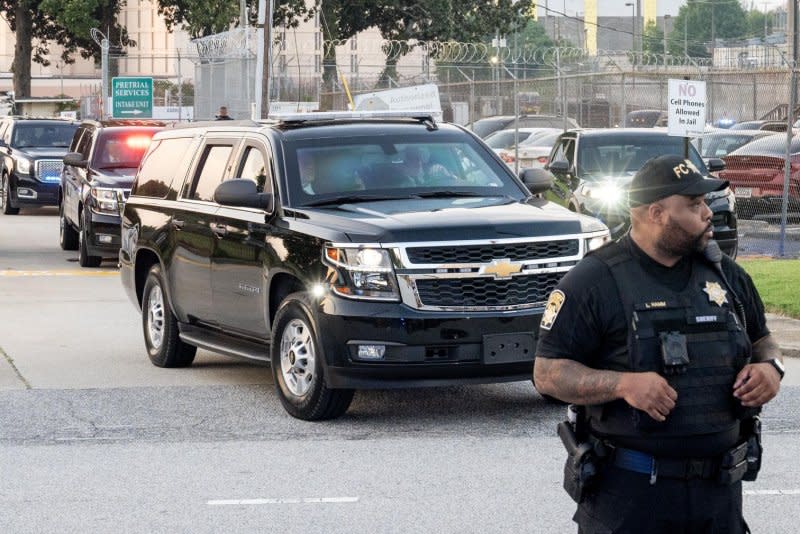 Former president Donald Trump's motorcade leaves the Fulton County Jail intake center in Atlanta on Thursday. Photo by Anthony Stalcup/UPI