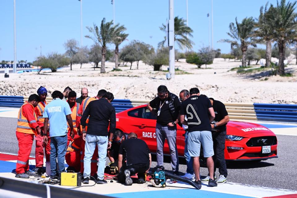 Circuit officials inspect the loose drain cover in Bahrain (Getty Images)