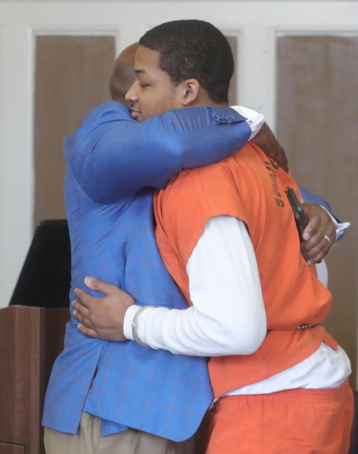 Defense attorney Walter Madison hugs Kavon Jackson on Monday in Akron after he entered a guilty plea for the fatal shooting of a William Howell II in 2021.