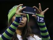 A Seattle Seahawks fan takes a picture from the stands as she attends Media Day for Super Bowl XLVIII at the Prudential Center in Newark, New Jersey January 28, 2014. REUTERS/Shannon Stapleton