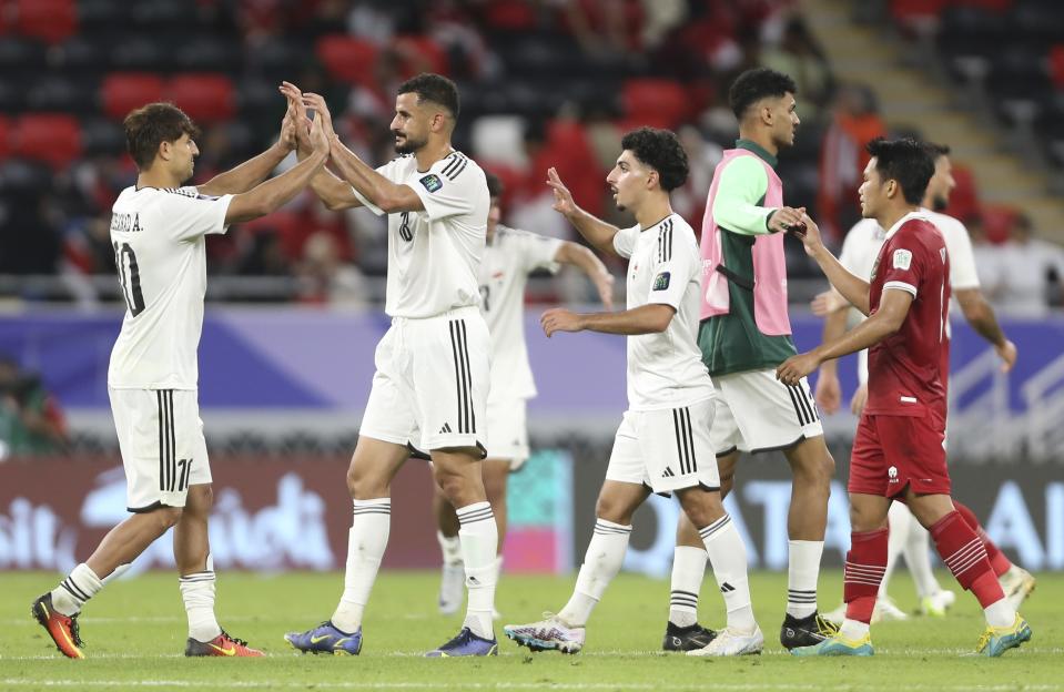 Iraq's players celebrate after they beat Indonesia during the Asian Cup Group D soccer match between Indonesia and Iraq at Ahmad Bin Ali Stadium in Al Rayyan, Qatar, Monday, Jan. 15, 2024. (AP Photo/Hussein Sayed)