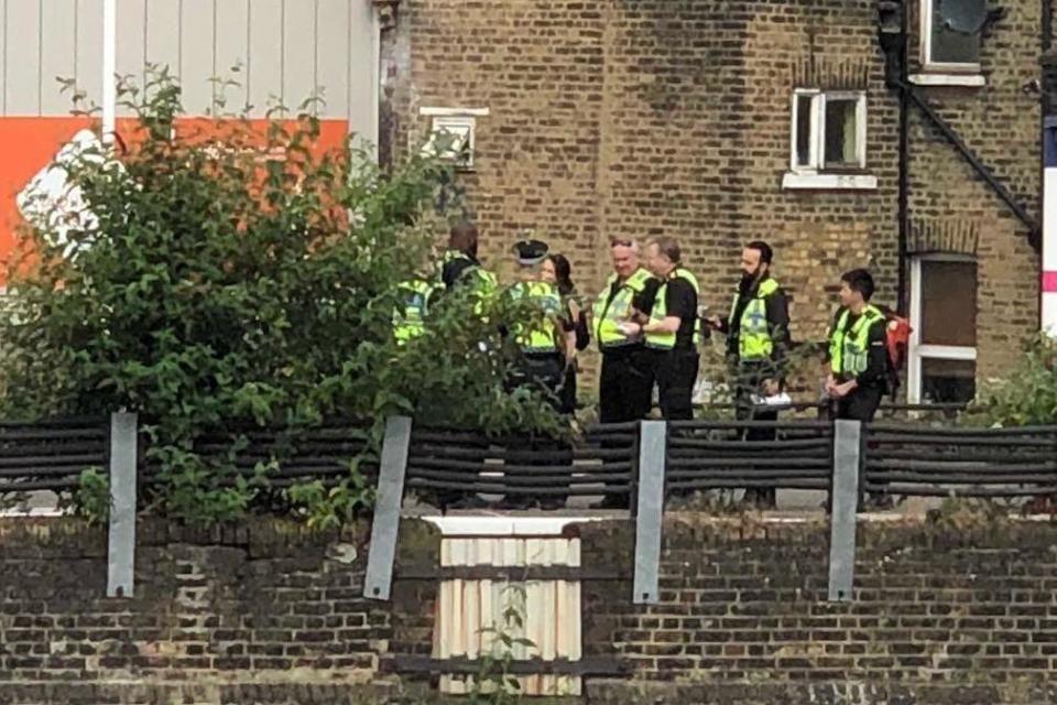 Police at the scene near Brixton after three people died when they were hit by a train