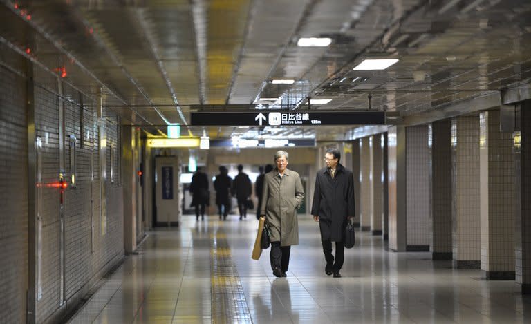 Businessmen walk on a concourse at a subway terminal in downtown Tokyo, on December 28, 2012. Japan's unemployment rate edged down to 4.2% in January while the struggling economy remained mired in deflation, according to the latest official data