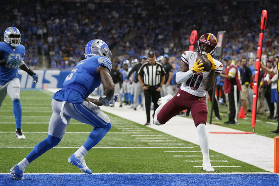 Washington Commanders wide receiver Curtis Samuel (10) makes a touchdown reception against Detroit Lions safety DeShon Elliott (5) during the second half of an NFL football game Sunday, Sept. 18, 2022, in Detroit. (AP Photo/Paul Sancya)