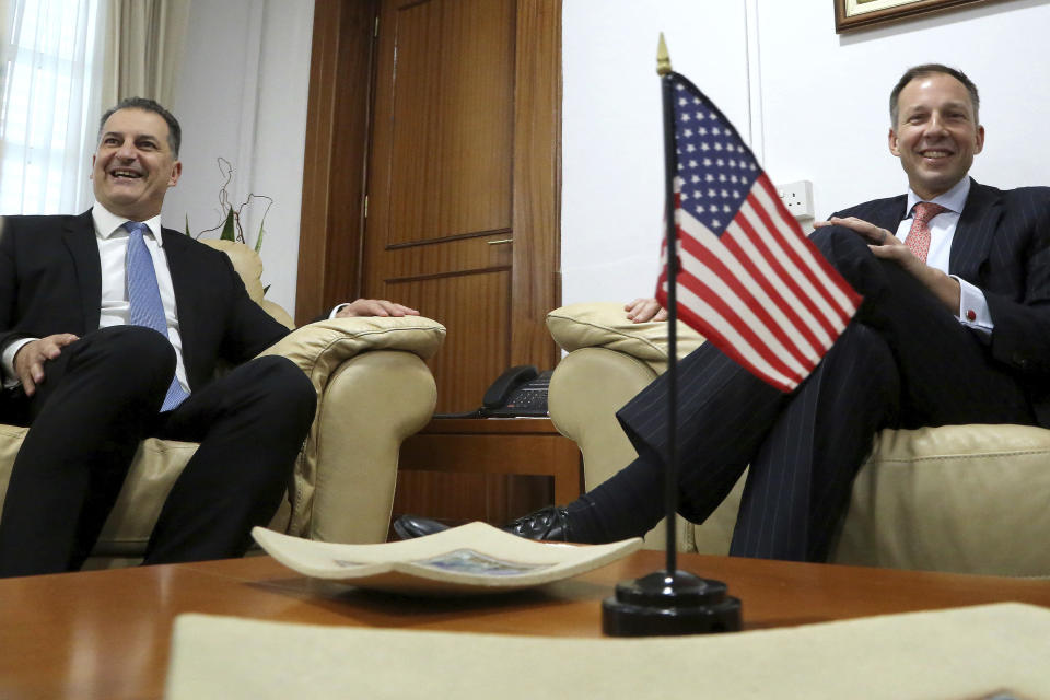 U.S. Assistant Secretary of State Francis Fannon, right, and Cyprus' Energy minister Yiorgos Lakkotrypis talk during their meeting at the Energy ministry in Nicosia, Cyprus, Friday, Nov. 16, 2018. Fannon visited Cyprus as part of a three-country tour in the region as ExxonMobil is ready to start exploratory drilling in waters southwest of Cyprus. (AP Photo/Petros Karadjias)