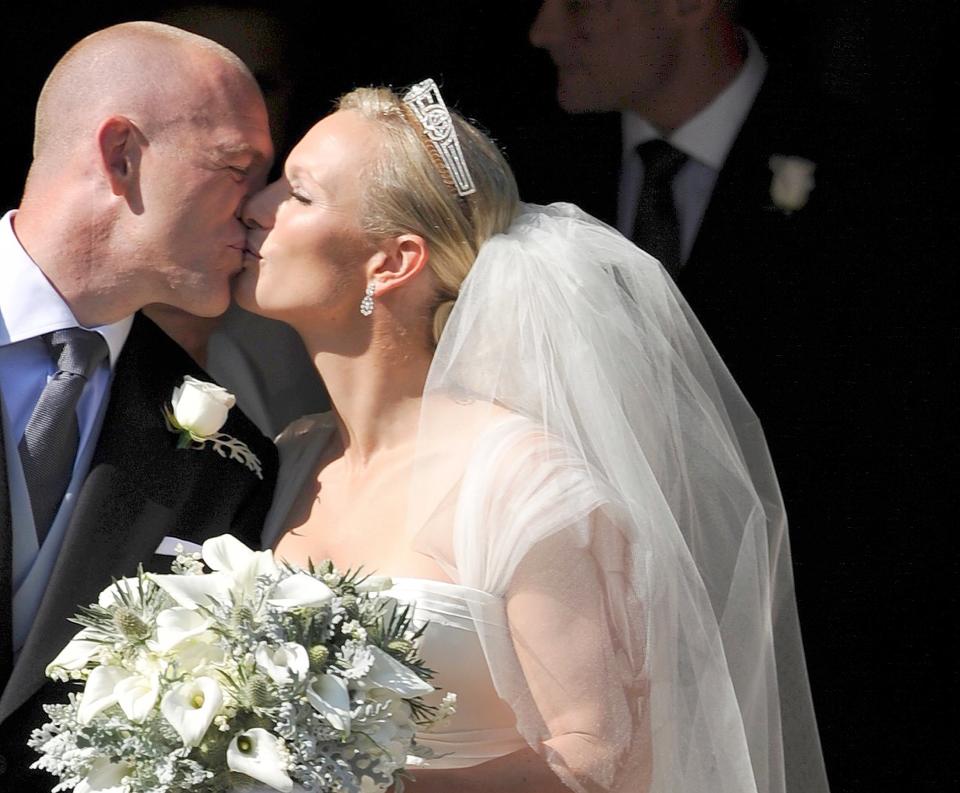 The newlyweds shared a kiss under the grand archway of the 17th-century church.