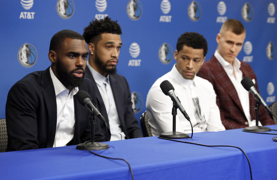 Tim Hardaway Jr., from left, responds to a question as Courtney Lee, Trey Burke and Kristaps Porzingis, right, listen during a news conferences where the newly acquired Dallas Mavericks players were introduced in Dallas, Monday, Feb. 4, 2019. (AP Photo/Tony Gutierrez)