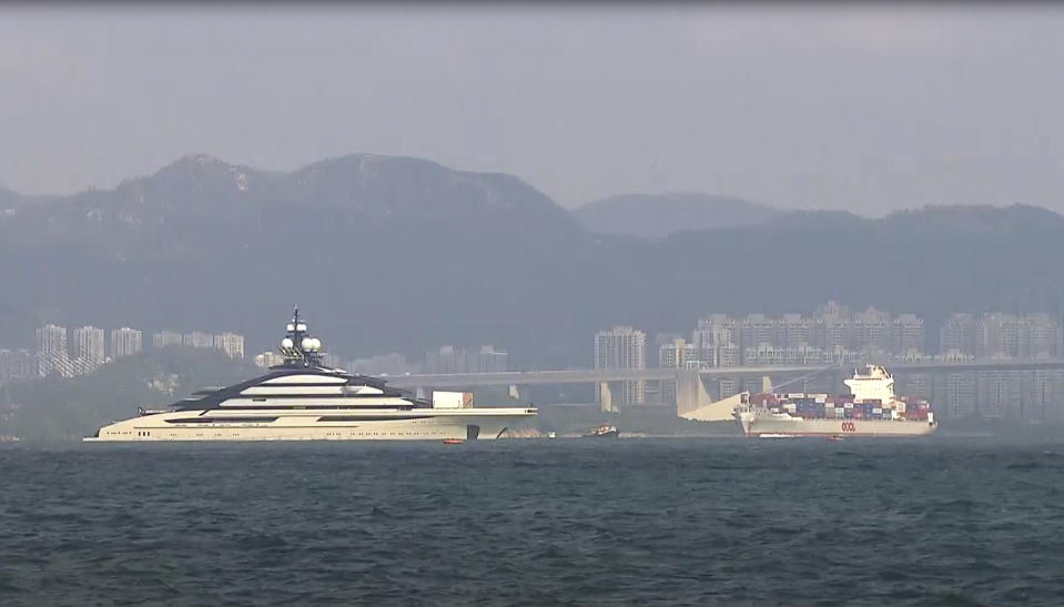 In this image taken from video footage run by TVB, the megayacht Nord, left, worth over $500 million, is seen off Hong Kong Island outside Victoria Harbour on Friday, Oct. 7, 2022. The superyacht connected to Russian tycoon Alexey Mordashov has anchored in Hong Kong this week amid moves by Western governments to seize yachts connected to sanctioned Russian businessmen. (TVB via AP)