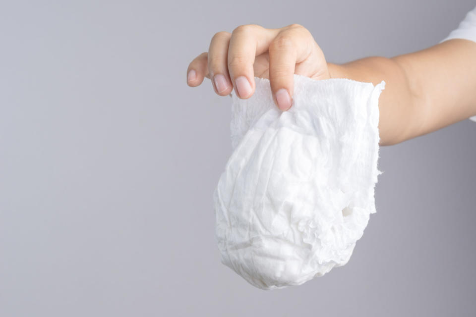 A person holding a diaper