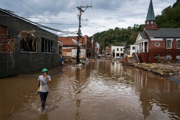 Workers, community members and business owners clean up debris in the aftermath of Hurricane Helene in Marshall, North Carolina, on Sept. 30, 2024.