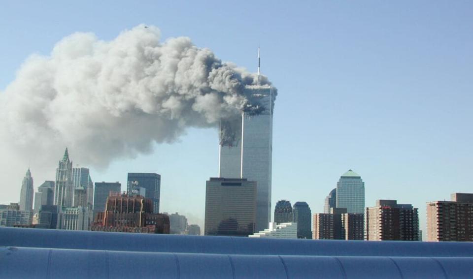 Smoke pours from the World Trade Center after being hit by two planes September 11, 2001 in New York City. (Photo by Fabina Sbina/ Hugh Zareasky/Getty Images)