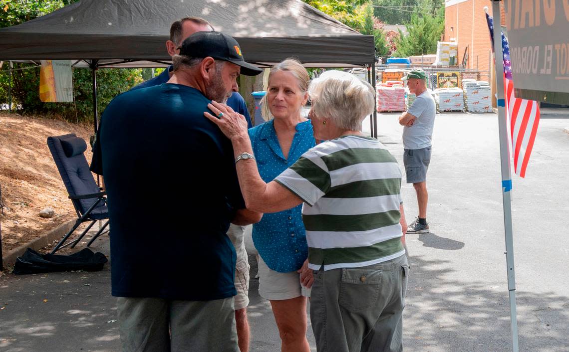 Sharon Durst, leader of the secessionist El Dorado state movement, talks with former supervisor Ray Nutting at their booth in Placerville on Sept. 13.
