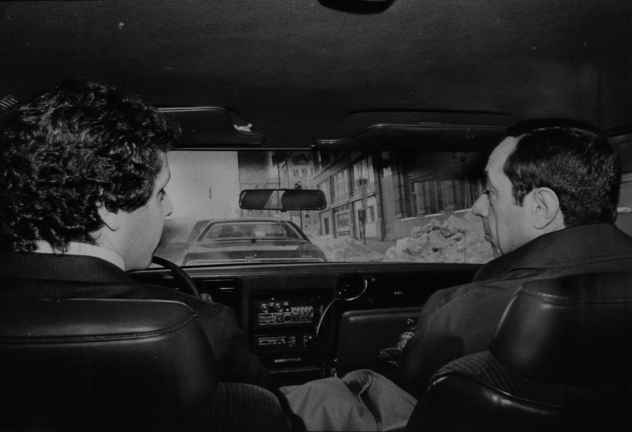 Mario Cuomo, right, rides in car as son Andrew drives on Jan. 20, 1983.