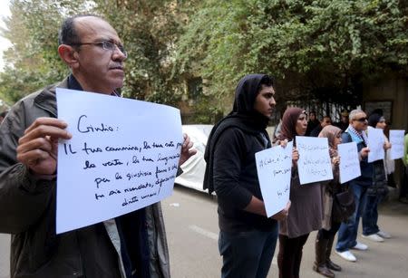 Activists hold placards that read, among others, "Giulio, one of us and killed like us", during a memorial for Giulio Regeni outside of the Italian embassy in Cairo, Egypt, February 6, 2016. REUTERS/Mohamed Abd El Ghany