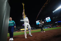 Seattle Mariners' Luke Raley, center, holds up a trident to celebrate a win over the Kansas City Royals in a baseball game Monday, May 13, 2024, in Seattle. (AP Photo/Lindsey Wasson)