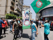 Supporters of Amal Movement hold a picture depicting Nabih Berri and missing Shi'ite Imam Musa al-Sadr as they celebrate Berri's re-election as parliament speaker in Beirut, Lebanon May 23, 2018. REUTERS/Aziz Taher