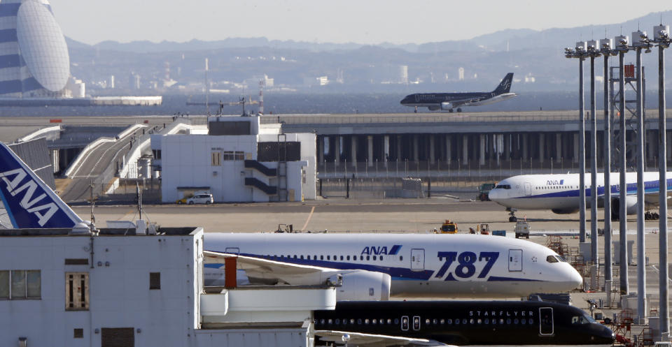 In this Friday, Jan. 18, 2013 photo, a grounded All Nippon Airways' Boeing 787 is parked on the tarmac at Haneda airport in Tokyo. Japan's transport safety agency says a lithium ion battery on a Boeing 787 that overheated during an All Nippon Airways flight earlier this month, prompting an emergency landing, was not overcharged. (AP Photo/Koji Sasahara)