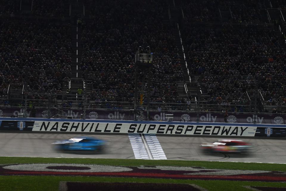 Ross Chastain leads as drivers pass in front of the grand stands during the 2023 Ally 400 at Nashville Superspeedway.