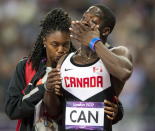 Canada's Justyn Warner is comforted after the Canadian relay team had their third place finish disqualified in the men's 4x100 metre final at the 2012 Summer Olympics in London, Saturday, August 11, 2012.THE CANADIAN PRESS/Ryan Remiorz