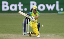 FILE - In this Nov. 9, 2020, file photo, Australia's David Warner plays a reverse sweep shot during the one day international cricket match between India and Australia at the Sydney Cricket Ground in Sydney, Australia. Once the best all-format opener in the game, Warner comes into the World Cup with no form and is perhaps emblematic of Australia's preparations for the competition. (AP Photo/Rick Rycroft, File)