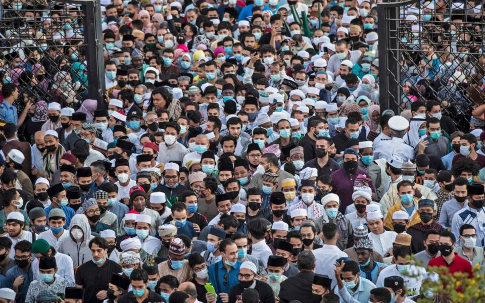 Muslim worshippers arrive to attend Eid al-Fitr prayer, which marks the end of the holy fasting month of Ramadan - Khaled Desouki