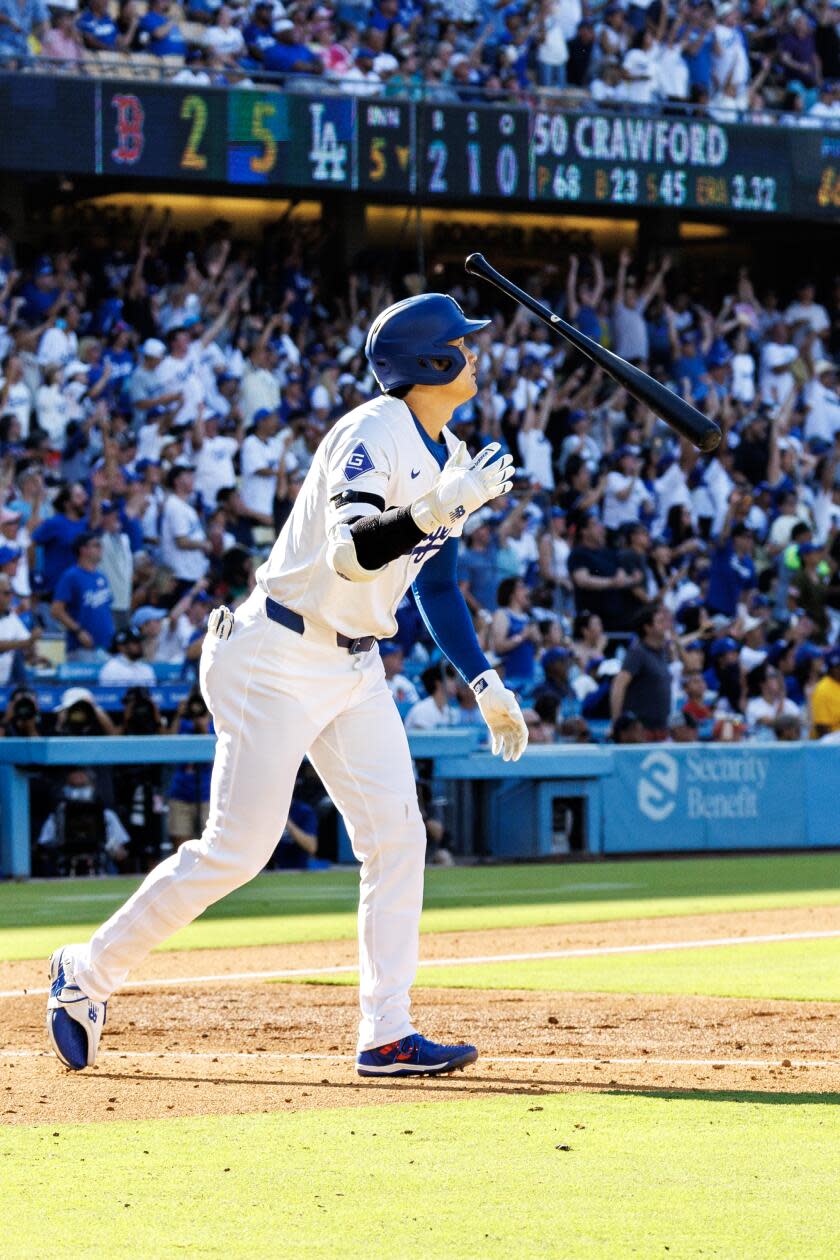 Dodgers star Shohei Ohtani tosses his bat after hitting a 473-foot home run at Dodger Stadium.