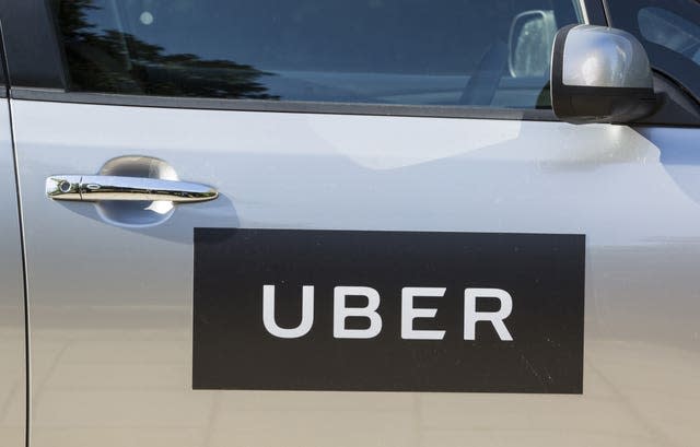 The logo of Uber on a car door (Laura Dale/AP)