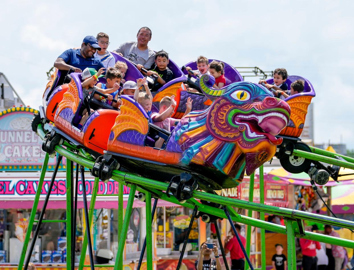 Festival-goers ride the Iron Dragon roller coaster at the 180th Waukesha County Fair on Sunday, July 24, 2022. The five-day festival includes carnival rides, live music, food, livestock auctions and much more.