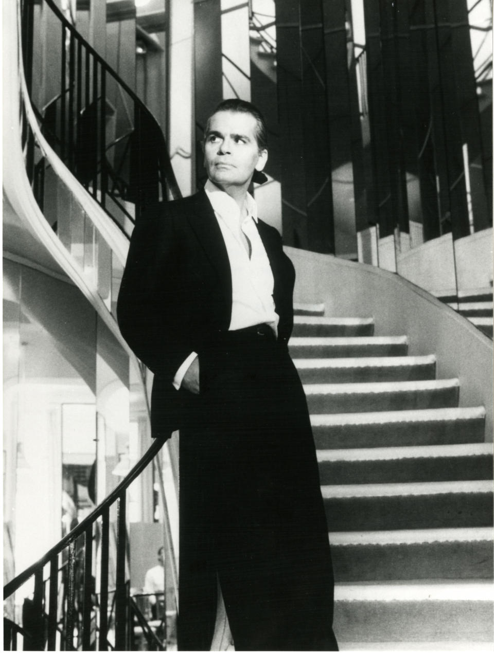 Karl Lagerfeld photographed by Helmut Newton on the mirrored staircase at 31 Rue Cambon.