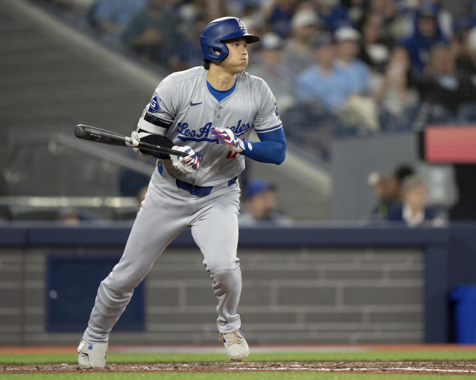 Los Angeles Dodgers designated hitter Shohei Ohtani starts up the base path after hitting a line drive to second base during fourth-inning baseball game action against the Toronto Blue Jays in Toronto, Sunday, April 28, 2024. (Frank Gunn/The Canadian Press via AP)