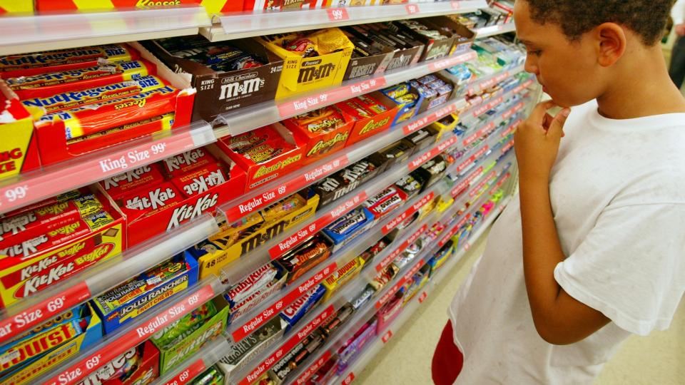 Child picking out sweets in a shop