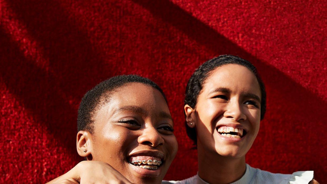 Women smiling and hugging each other